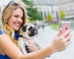 Woman with dog taking selfie